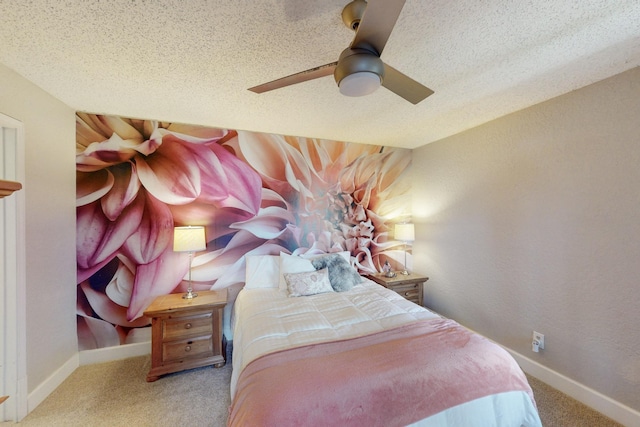 bedroom featuring ceiling fan, light carpet, and a textured ceiling