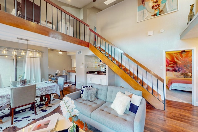 living room with dark hardwood / wood-style floors and a high ceiling