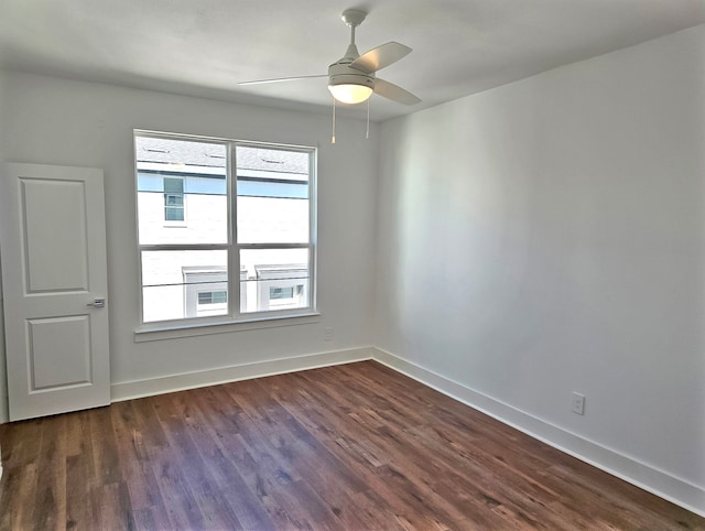 unfurnished room with dark hardwood / wood-style flooring and ceiling fan