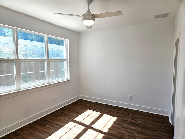 empty room with ceiling fan and dark wood-type flooring