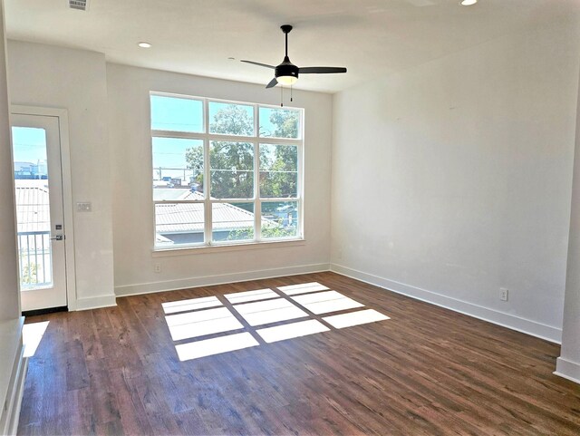 unfurnished room with ceiling fan and dark hardwood / wood-style flooring