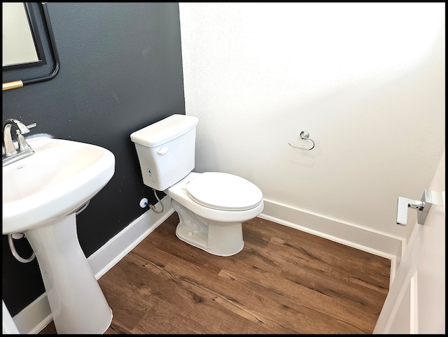 bathroom featuring sink, hardwood / wood-style floors, and toilet