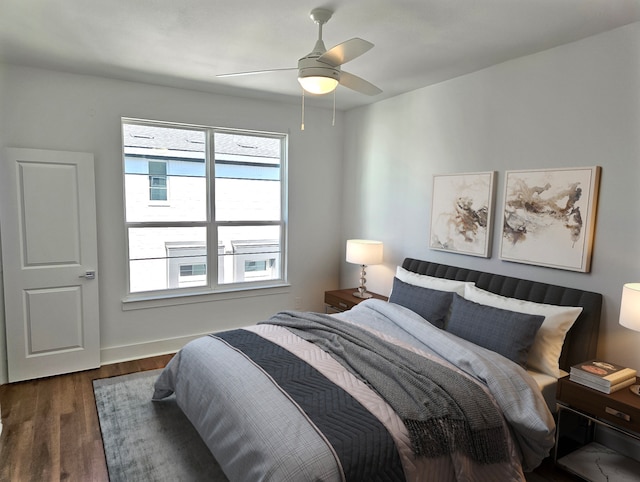 bedroom with ceiling fan and dark hardwood / wood-style floors