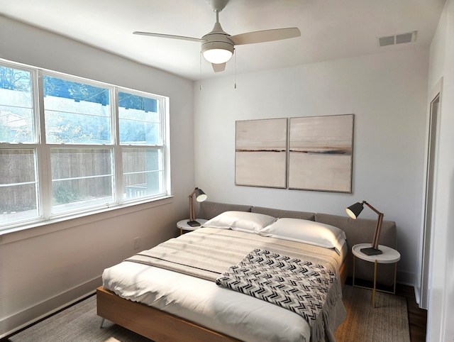 bedroom with dark hardwood / wood-style floors and ceiling fan