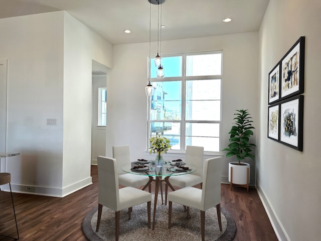 dining area featuring dark wood-type flooring