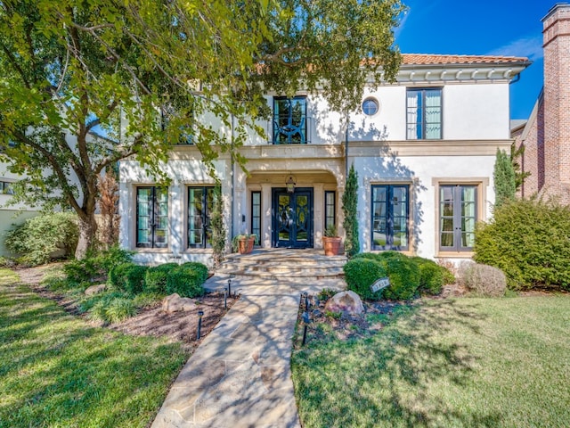 view of front of home featuring a front yard and french doors