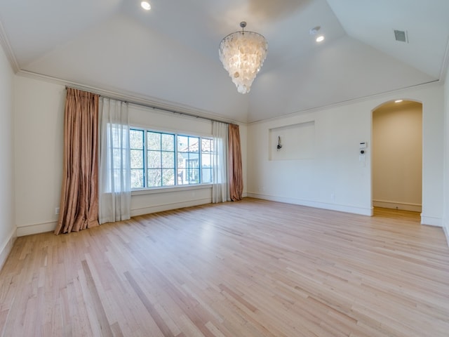 empty room with ornamental molding, an inviting chandelier, light hardwood / wood-style flooring, and lofted ceiling