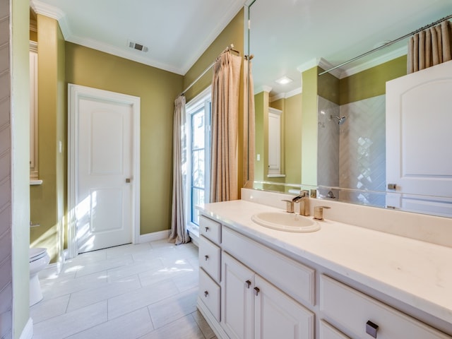 bathroom with tile patterned floors, toilet, tiled shower, vanity, and ornamental molding