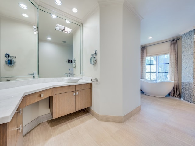 bathroom featuring vanity, crown molding, and a tub to relax in