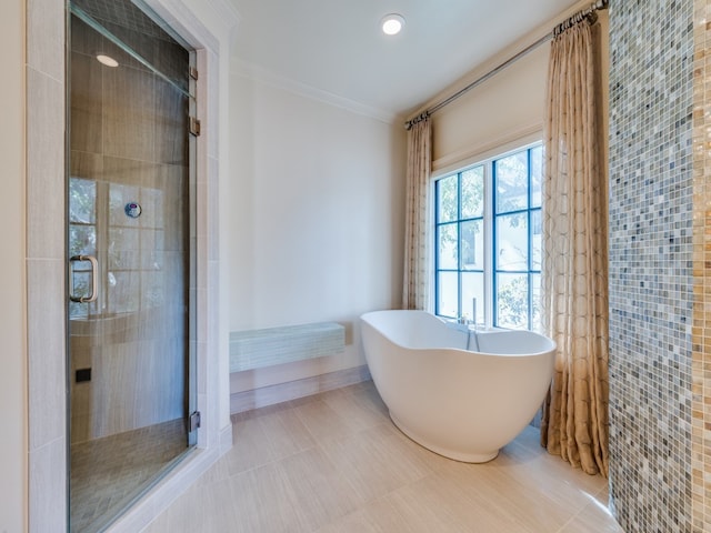 bathroom with separate shower and tub and ornamental molding