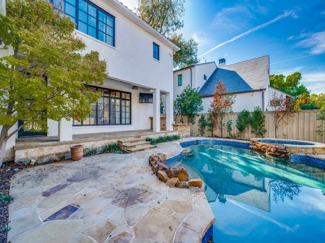 view of swimming pool with an in ground hot tub and a patio