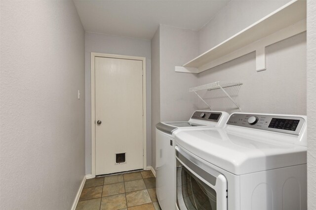 laundry room featuring separate washer and dryer and light tile patterned flooring