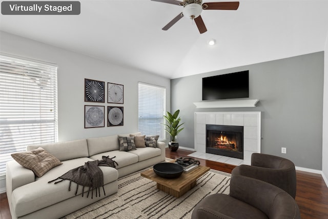 living room featuring a fireplace, hardwood / wood-style floors, a wealth of natural light, and lofted ceiling