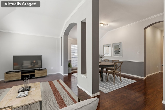 living room with ornamental molding, dark wood-type flooring, and vaulted ceiling