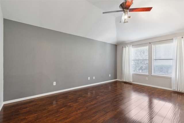 empty room with ceiling fan, lofted ceiling, and dark wood-type flooring