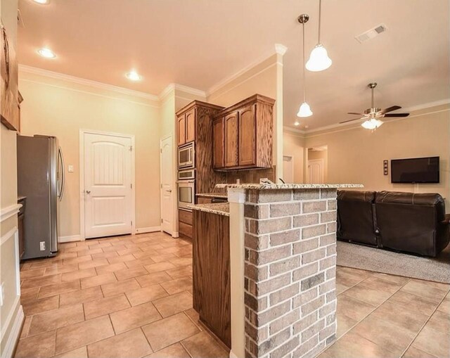 kitchen featuring appliances with stainless steel finishes, light stone counters, ceiling fan, crown molding, and hanging light fixtures