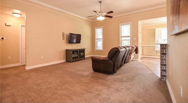 living room with carpet floors, ceiling fan, and crown molding