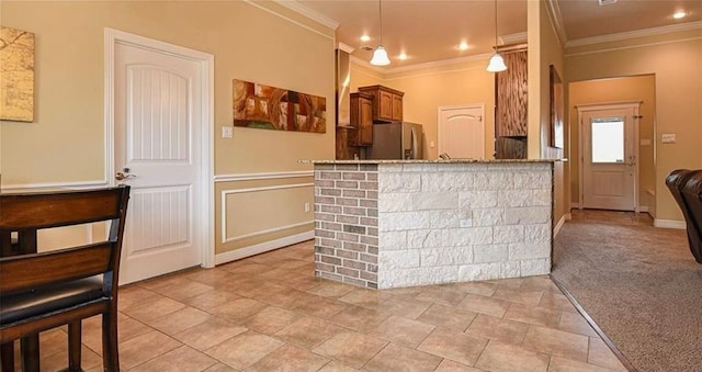 kitchen featuring light carpet, stainless steel refrigerator with ice dispenser, decorative light fixtures, and ornamental molding