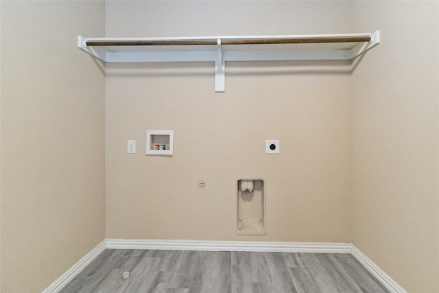 laundry area with hardwood / wood-style floors, electric dryer hookup, hookup for a gas dryer, and hookup for a washing machine