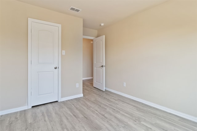 unfurnished bedroom with light wood-type flooring