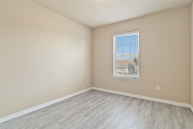 spare room featuring light wood-type flooring