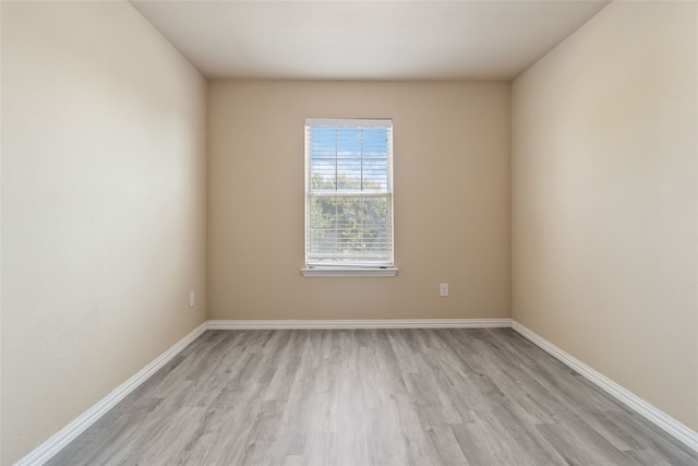 unfurnished room with light hardwood / wood-style floors