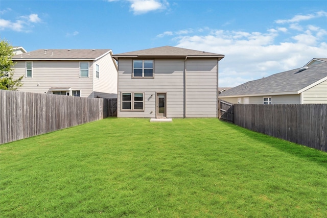 rear view of house with a yard