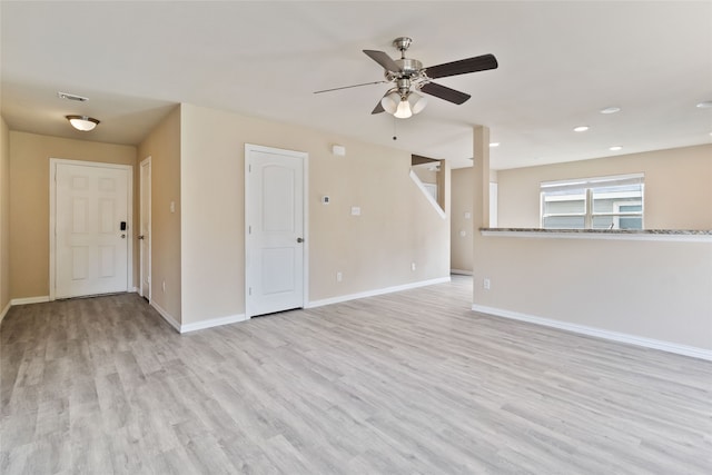 unfurnished living room featuring ceiling fan and light hardwood / wood-style flooring