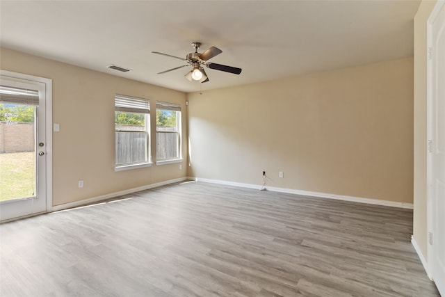 spare room featuring ceiling fan and light hardwood / wood-style flooring