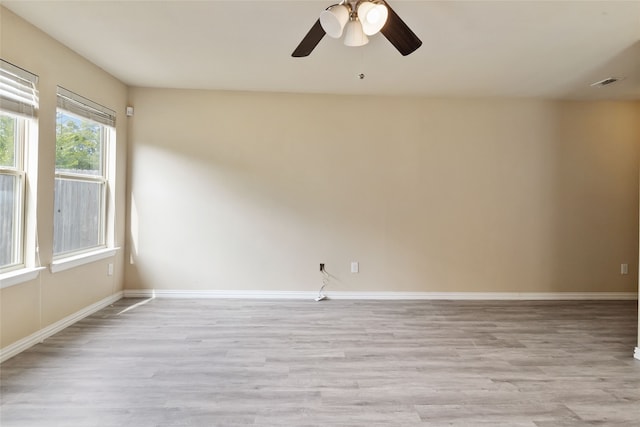 spare room featuring ceiling fan and light hardwood / wood-style flooring