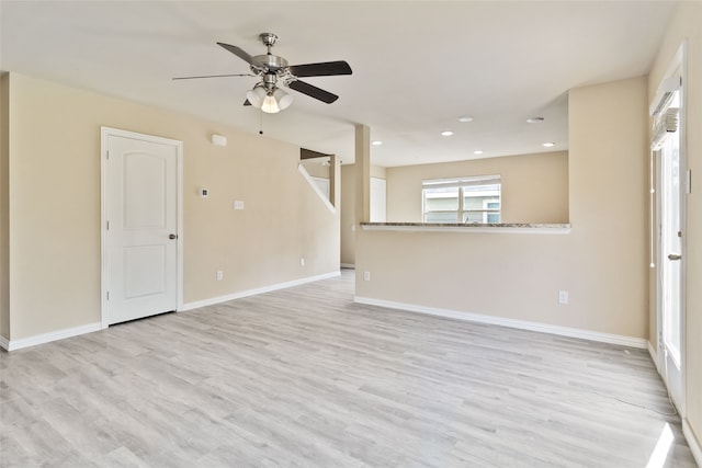 empty room featuring ceiling fan and light wood-type flooring