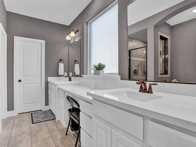 bathroom featuring tile patterned floors, vanity, and walk in shower