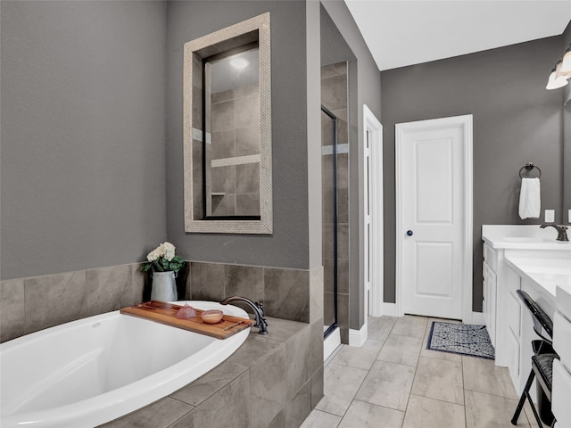 bathroom with vanity, tile patterned flooring, and plus walk in shower