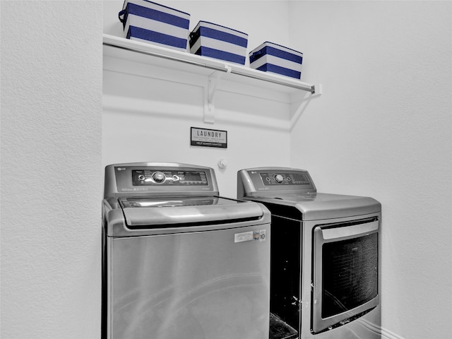 clothes washing area with washing machine and clothes dryer