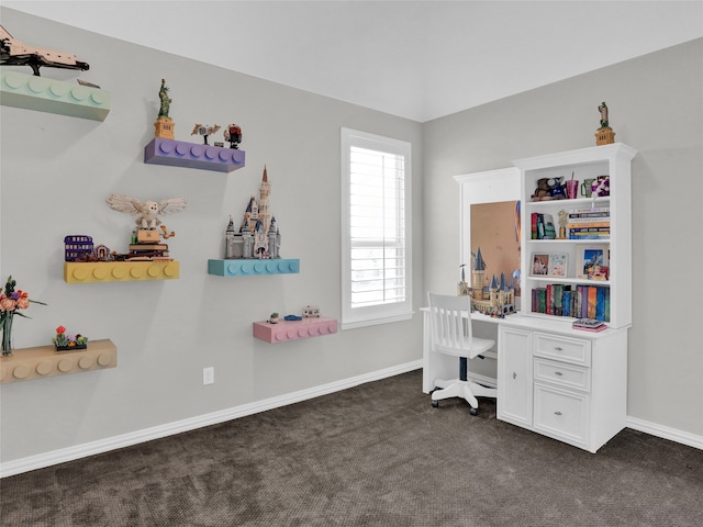 carpeted office space with built in desk