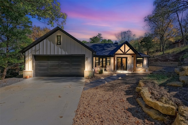 modern inspired farmhouse featuring french doors and a garage