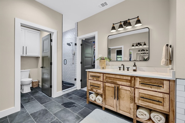 bathroom featuring vanity, toilet, and a shower with door