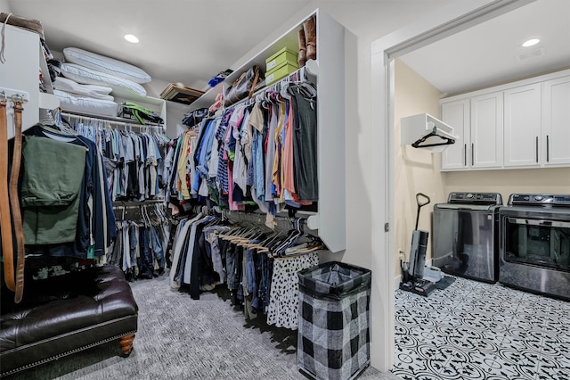 walk in closet featuring washing machine and clothes dryer