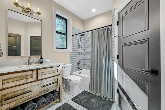 full bathroom with tile patterned flooring, shower / tub combo, vanity, and toilet