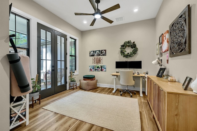 office space featuring ceiling fan, french doors, and light hardwood / wood-style floors