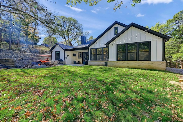 back of house with a patio area and a yard