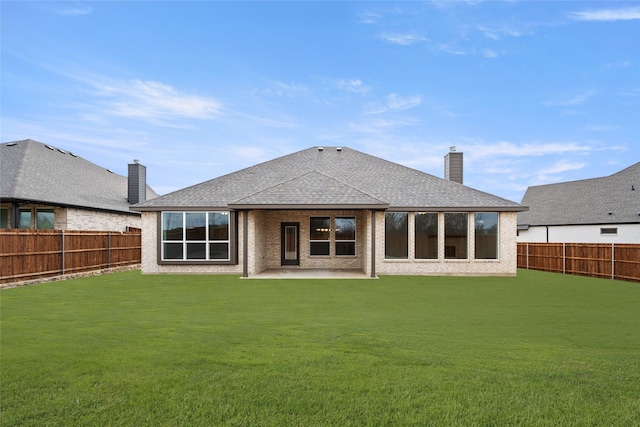 back of property featuring a patio area and a yard