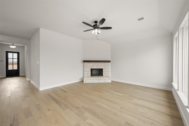 unfurnished living room with light hardwood / wood-style floors, ceiling fan, and a fireplace