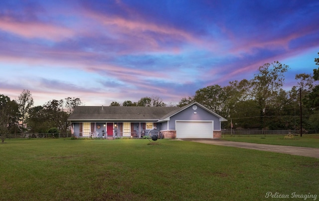 single story home with a yard and a garage