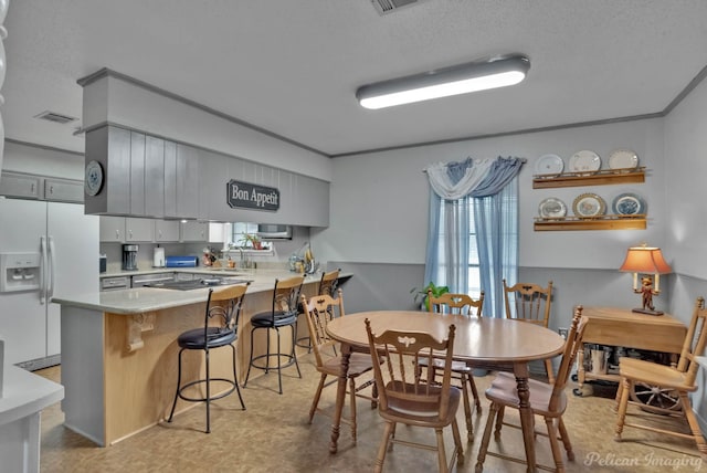 dining room with sink and a textured ceiling