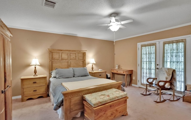 carpeted bedroom with french doors, a textured ceiling, ceiling fan, and crown molding