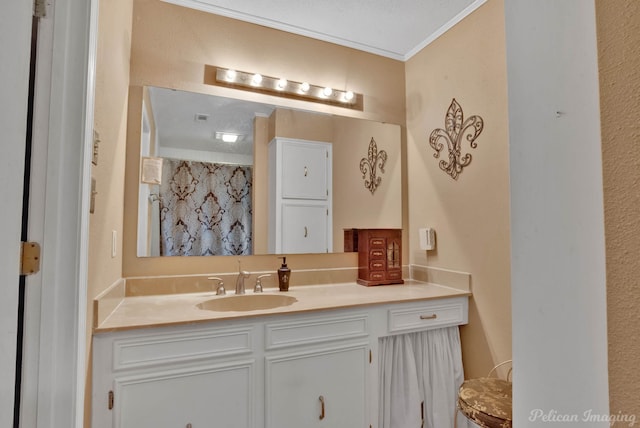 bathroom featuring vanity, a textured ceiling, and crown molding