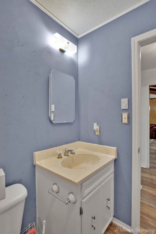 bathroom with wood-type flooring, a textured ceiling, and toilet