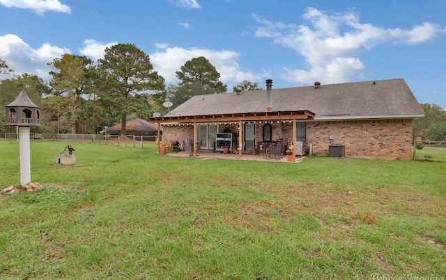 back of property featuring a yard, a patio area, and central air condition unit