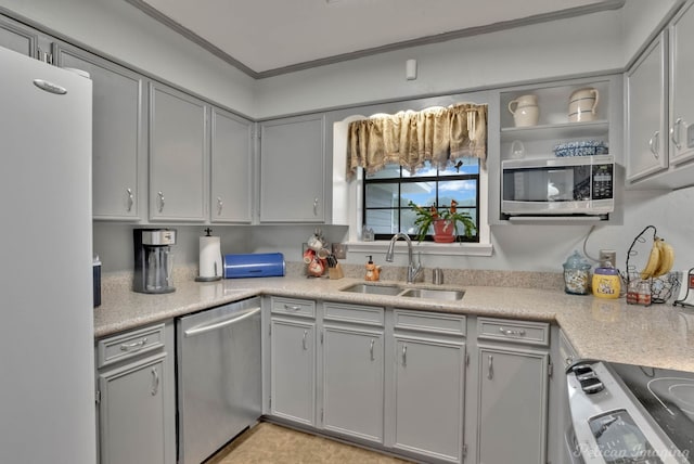 kitchen featuring gray cabinetry, crown molding, sink, and appliances with stainless steel finishes